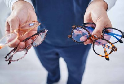 Optometry, glasses and hands of person with option for frame, prescription lens and spectacles for .