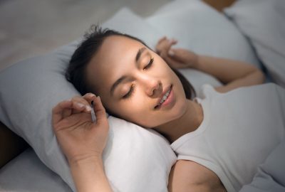 Young Woman Sleeping In Bed Comfortably And Blissfully Young Woman Sleeping In Bed Comfortably And Blissfully With Sunbeam Dawn On Her Face